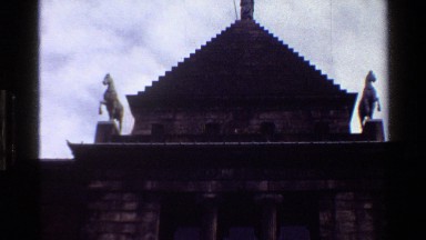 1983: exterior view of a monumental building, with its statues and a person