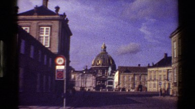 1983: streets around domed building with people walking around. DENMARK