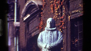 1983: a old church and a statue of a saint on a sunny day DENMARK