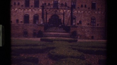1983: palace gate with ducks, later a woman petting a stone dog statue DENMARK