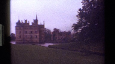 1983: view of old castle building with moat and creek, between surrounded by