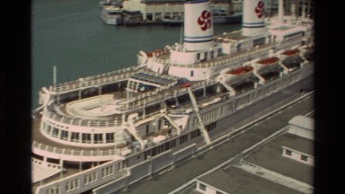 1981: Aerial View of Luxury Cruise Ship Docked in Hawaii Harbor