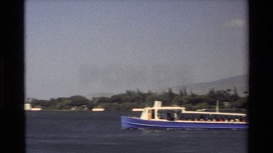 1981: Panning Views of Boat Passing Nearby Pearl Harbor Memorial and Flag