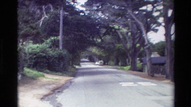 1982: sedan car drives down suburban street CARMEL CALIFORNIA