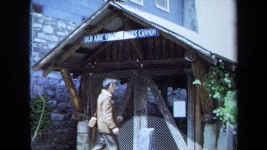 1971: Man Walking and Peeking Through Window in Maine Cabin