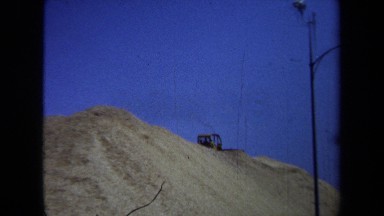 1971: blue collar workers building a bridge using heavy equipment MAINE