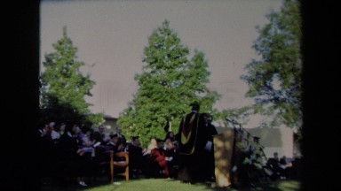 1971: alumni comes to the podium to speak after another speaker. SACRAMENTO