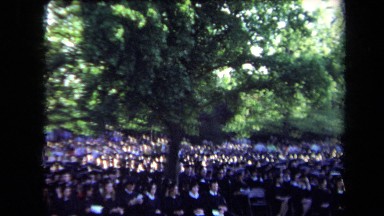 1971: hundreds of graduates sit in chairs wearing caps and gowns SACRAMENTO