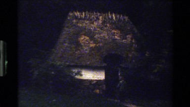 1983: person enters and descends into dark cottage and person exits