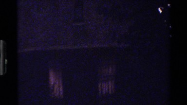 1983: this is a upward camera shot of a building that doesn't look like it is