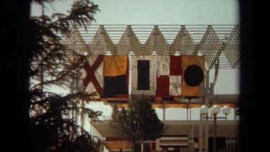 1971: five flats attached to a structure at the port waves in the breeze LAGUNA