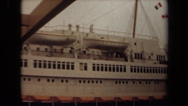 1971: flags from various countries hang on a line on ship LONG BEACH CALIFORNIA