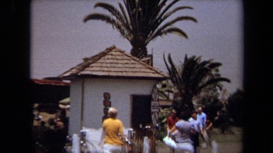 1971: a panoramic view of a group of people that are gathered together outside