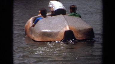 1971: three people navigate boat in small pond LAGUNA HILLS CALIFORNIA