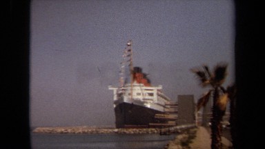 1971: an ocean liner is moored at a tropical port waterfront LONG BEACH