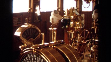 1971: horns, levers, button, and pipes of brass are seen on the bridge of a ship