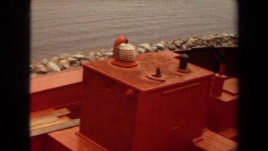1971: various rods and poles sit inside an orange and brown boat LONG BEACH