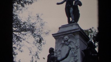1970: a twenty feet high monument in the middle of the park surrounded by trees