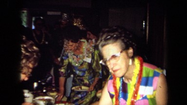 1971: People Collecting Food at Tropical Party in California