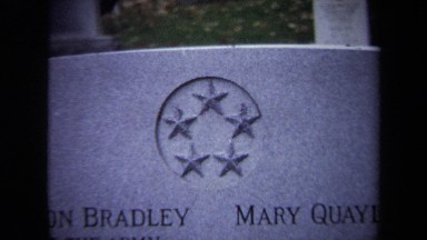 1970: A Close-Up Shot of a Gravestone in the Middle of a Cemetery
