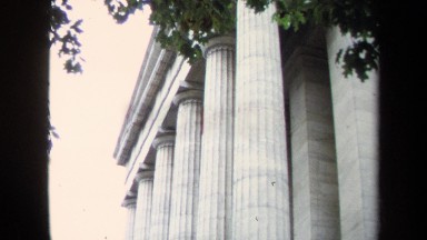 1970: Black Statue of Snake Around Extended Hooves Displayed Near Classic Building
