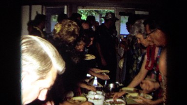 1971: party of people gathered around the dining table CALIFORNIA