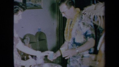 1961: large party gathered in warm weather wearing hawaiian shirts