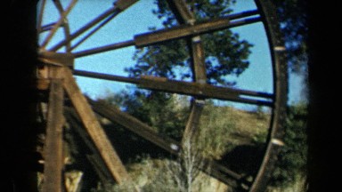 1969: A Woman Walking Behind a Very Large Abandoned Wooden Mill