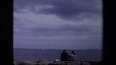 1970: A Man and Woman Sitting on Rocks Talking in Annapolis