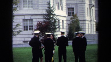 1970: a group of soldiers standing outside talking to a woman ANNAPOLIS