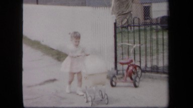 1958: Girl Playing with Baby Cart in New York