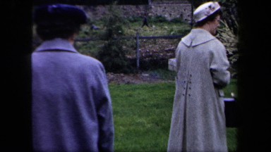 1958: Two Women Wearing Caps Walking in New York Park with Vintage Vehicles