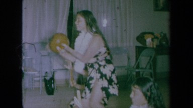1961: Young Women Dressed in Traditional Hawaiian Costumes Play Instruments and Dance