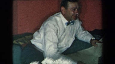 1959: Two Gentlemen in Suits Reading Newspaper in New York Living Room