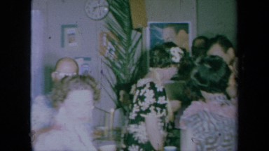 1961: Group of Adults Walking and Socializing at a Tropical-Themed Party