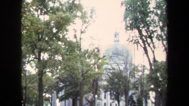 1970: View of Large White Housing Building Surrounded by Foliage in Annapolis