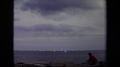 1970: Man in Red Shirt Playing at Seaside with Boats in Annapolis, Maryland
