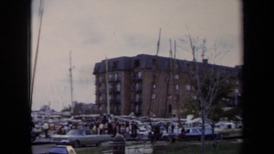 1970: Pedestrians and Drivers Move on Sidewalk and Street by Crowded Wharf