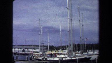 1970: Row of Boats with Tall Masts Sway at Corner of Piers