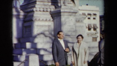 1959: Several People Pose in Front of a Monument in New York City During Autumn