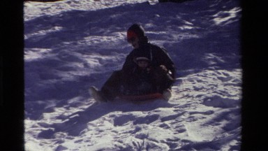 1981: Father and Son Snow Sledding on Orange Round Saucer Sled California
