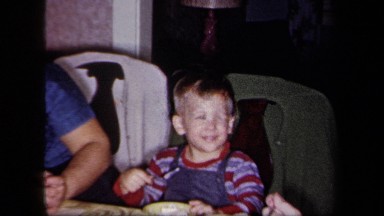 1958: Happy Toddler Eating at Table with Mom and Dad, New York