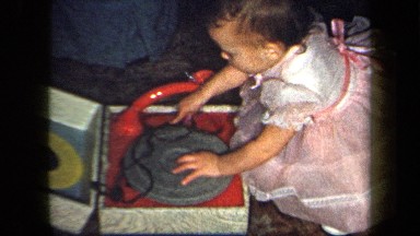 1958: A Child Playing With a Record Player in New York