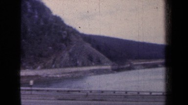 1959: Panorama of a Road with Cars and a Steep Rocky Slope Adjacent