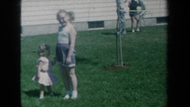 1959: Baby Plays in New York Park with Family During Holiday