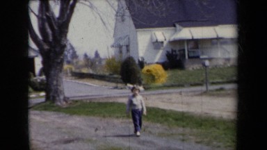 1959: Child Walking on Path Parallel to Dirt Road in Rural New York