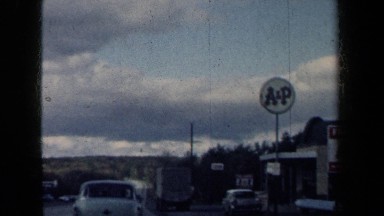 1959: A White Car Moving on a Road with No People in New York
