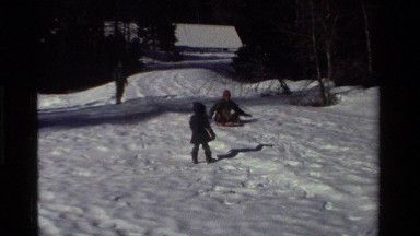 1981: an elderly man sleds down a snowy pathway CALIFORNIA