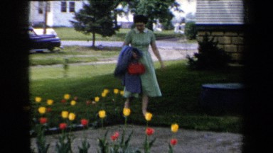 1959: A Woman Walking Toward the Flower Patch in New York