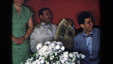 1959: Man Reading Newspaper with Family in New York